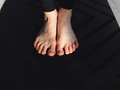 Close up of feet on a professional yoga mat.