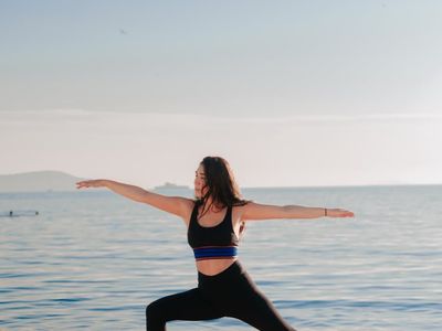 Outdoor yoga session at sunrise with green background.