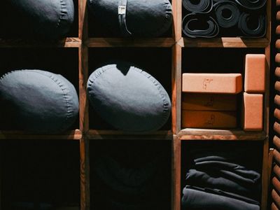Yoga blocks and accessories arranged neatly on floor.